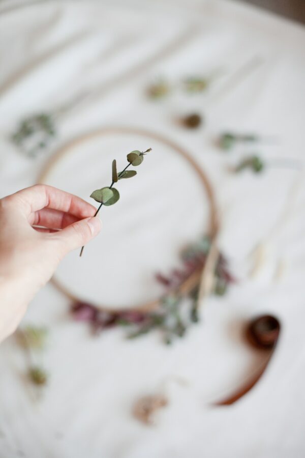 Winter handmade - woman making a minimalist christmas wreath, hands, craft, hobby, dry flowers